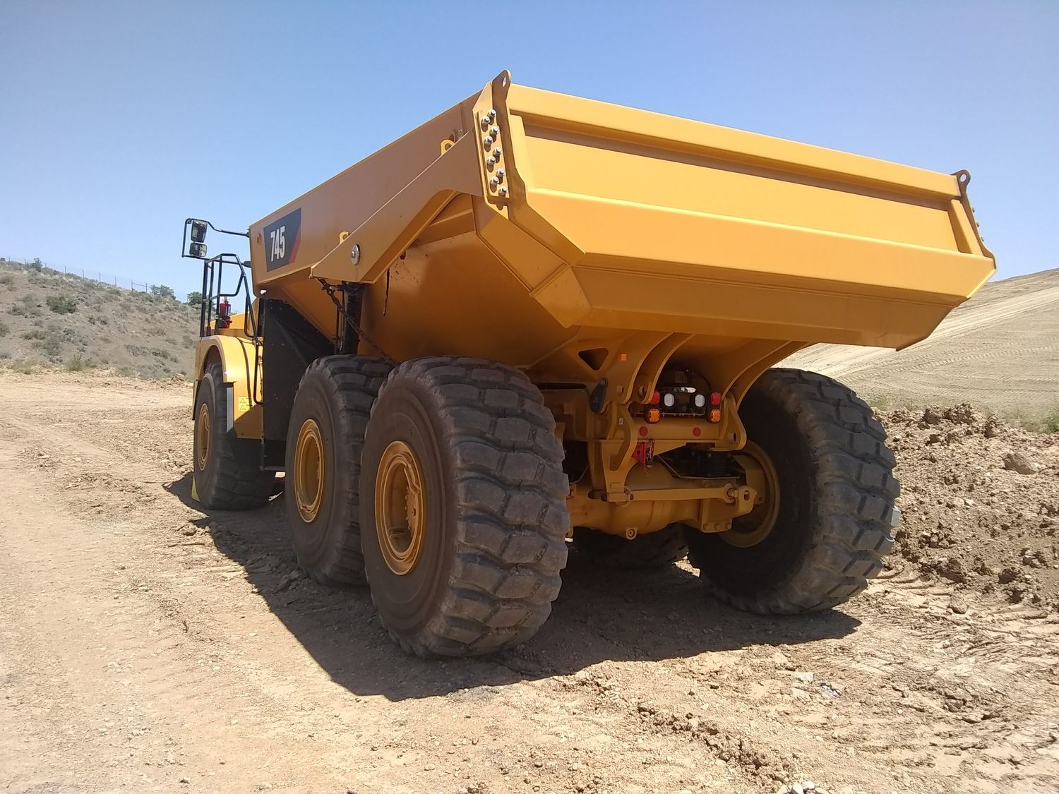 CAT 745 haul truck parked on the pad.
