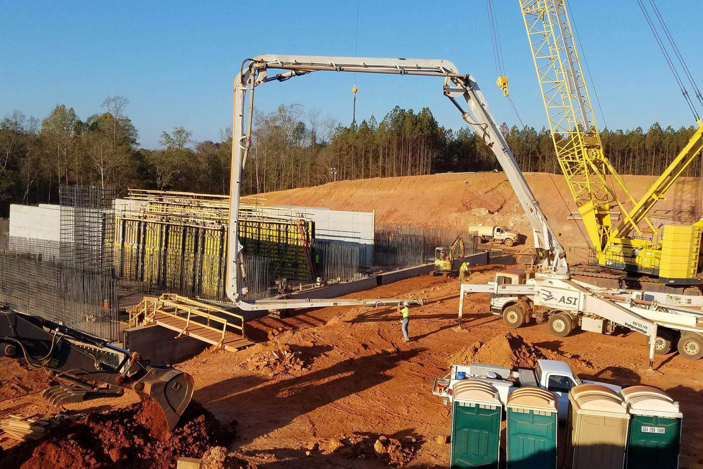 Cat dozer working an embankment with finished spillway steps behind.