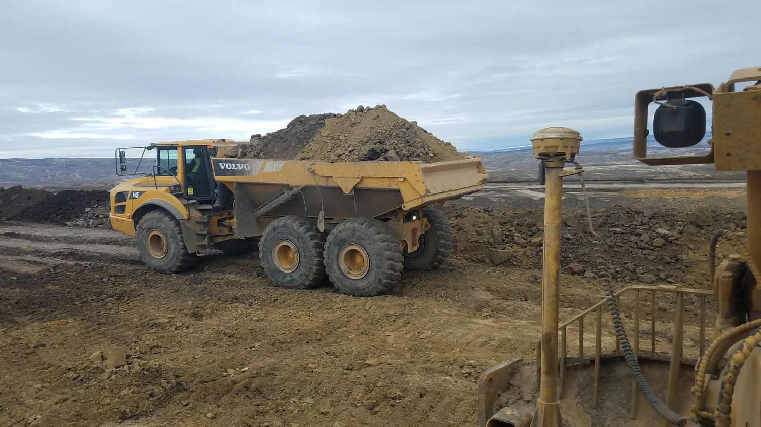 Volvo A40F articulated truck loaded with cut material.