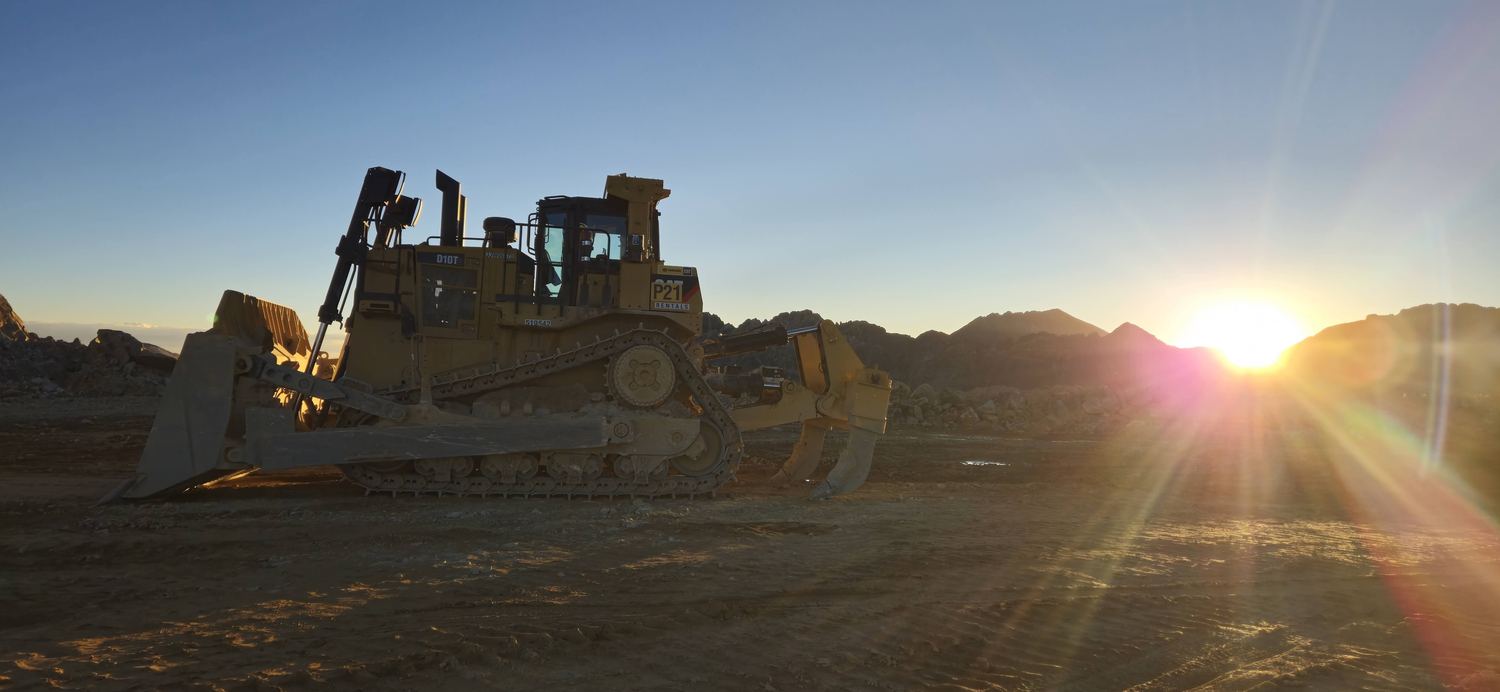 CAT D10T dozer with ripper at sunset.