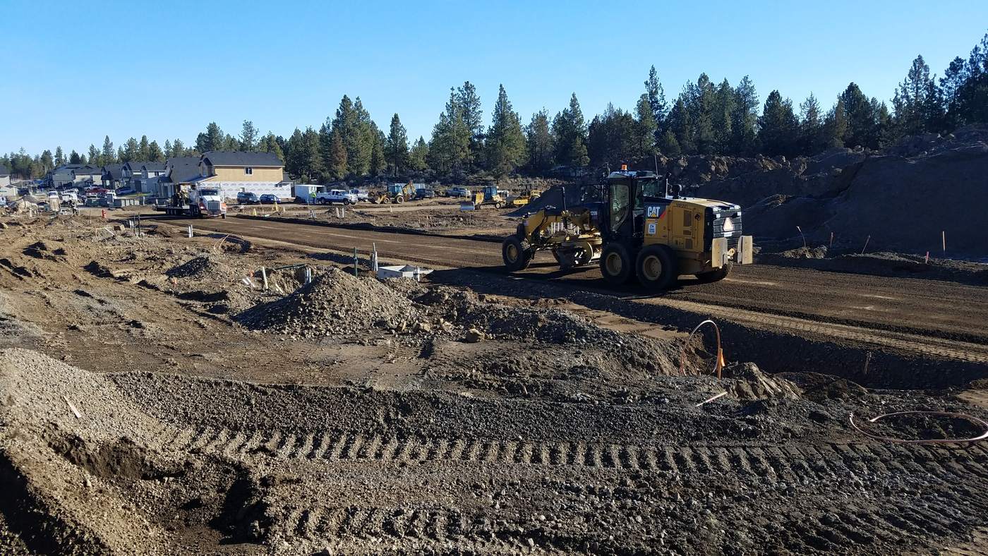 Motor grader shaping a subdivision road in central Oregon.