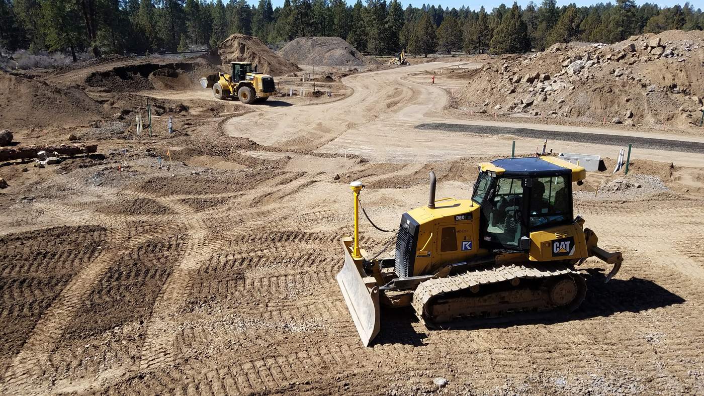 Dozer and loader working roads and lots on a central Oregon subdivision.